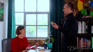 Vee reads aloud from the filthy book as the librarian holds a strap