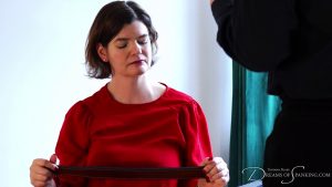 The librarian holds a strap and looks down thoughtfully