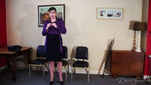 Blake prepares to remove her blouse as she gets ready for her punishment