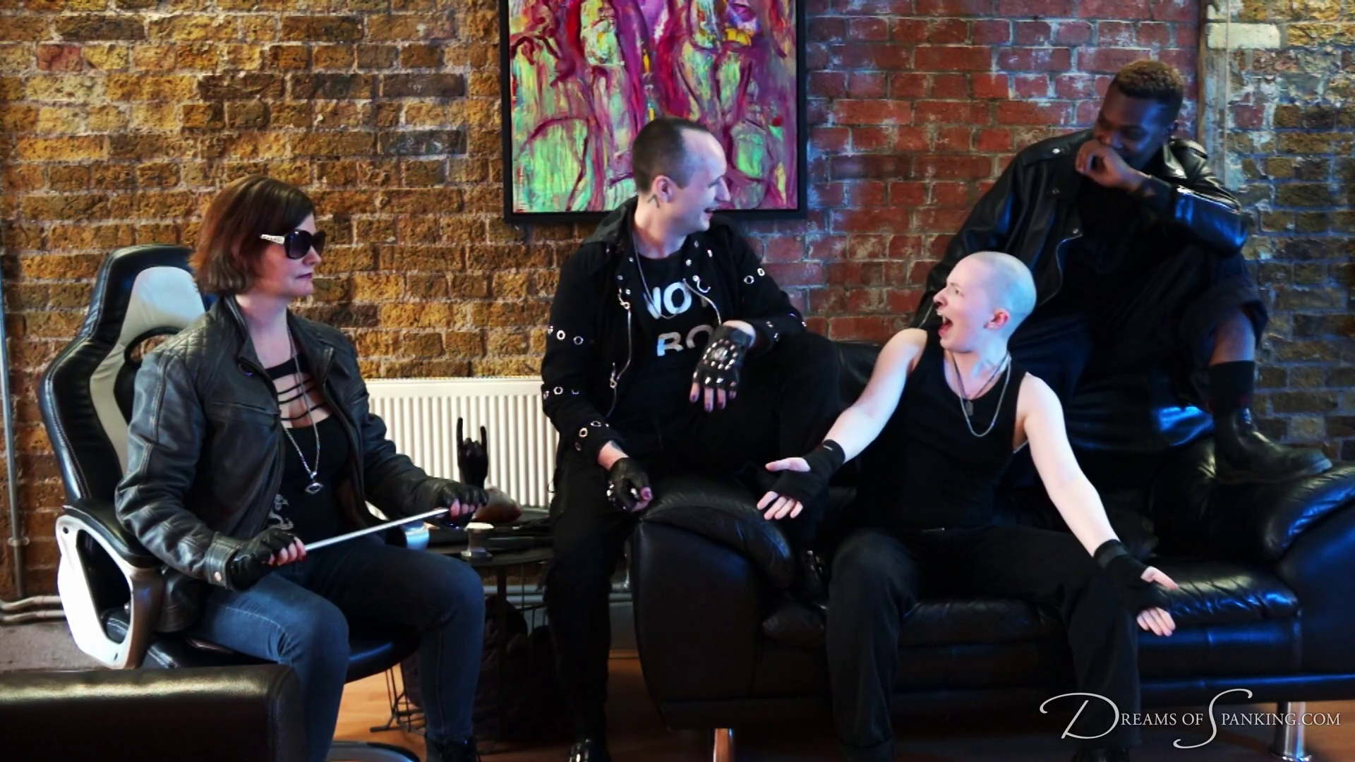 The three gang members and their boss sit together and laugh about their recently completed job