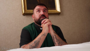 The priest prays for deliverance by his bed